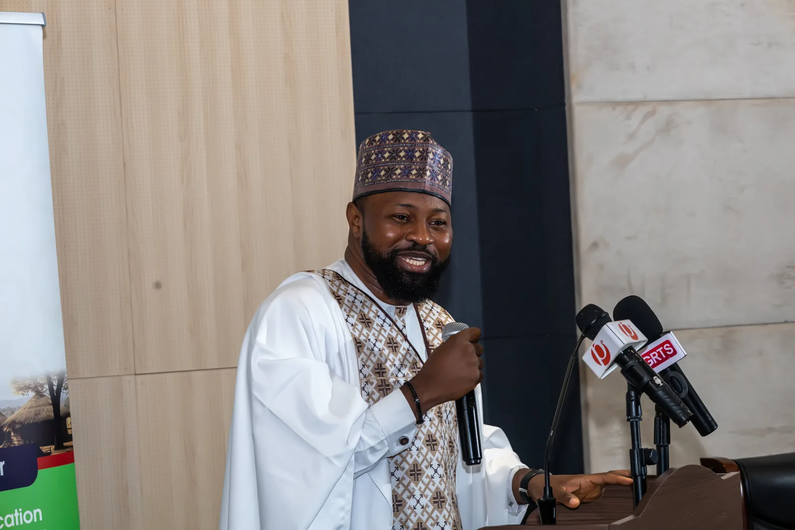 A speaker addressing an audience at a lectern