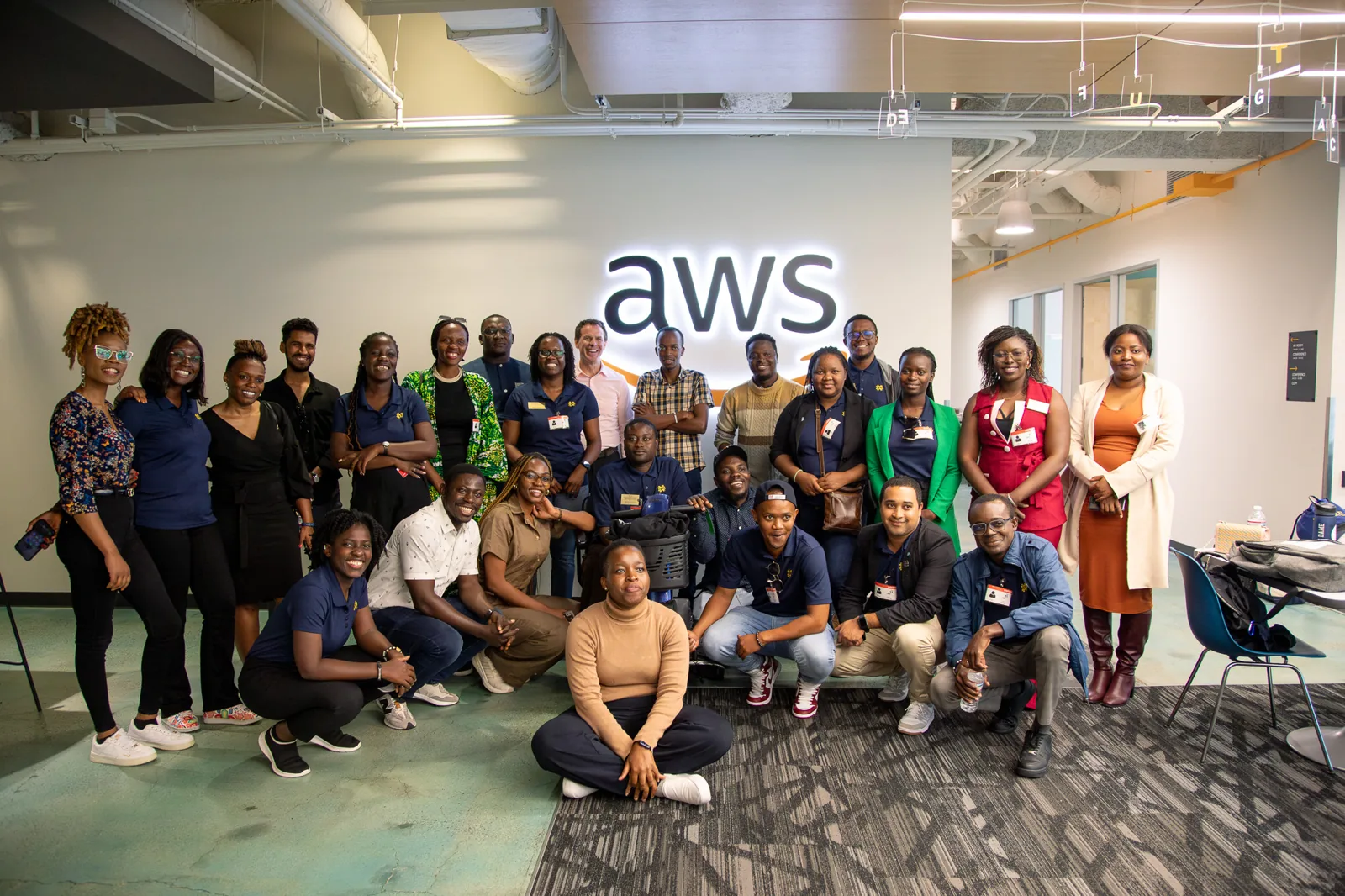 A group posing in front of an AWS backdrop