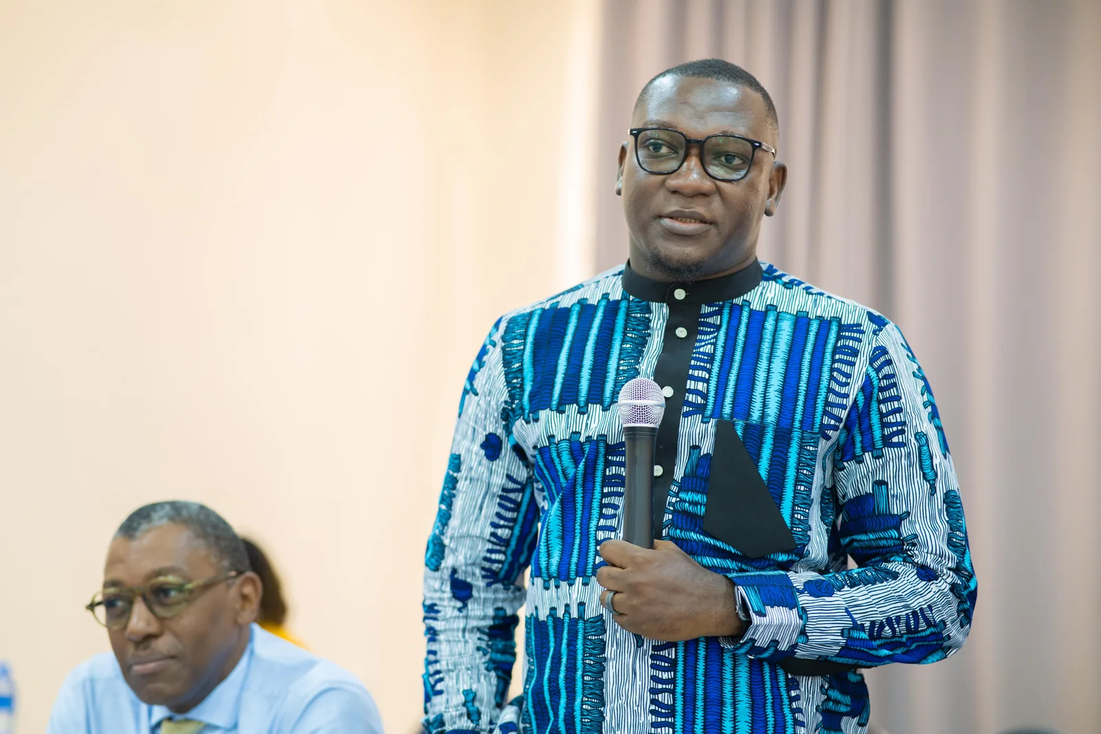 David Jeng addressing participants with a microphone