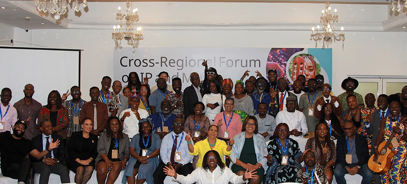 Participants together in front of the event backdrop