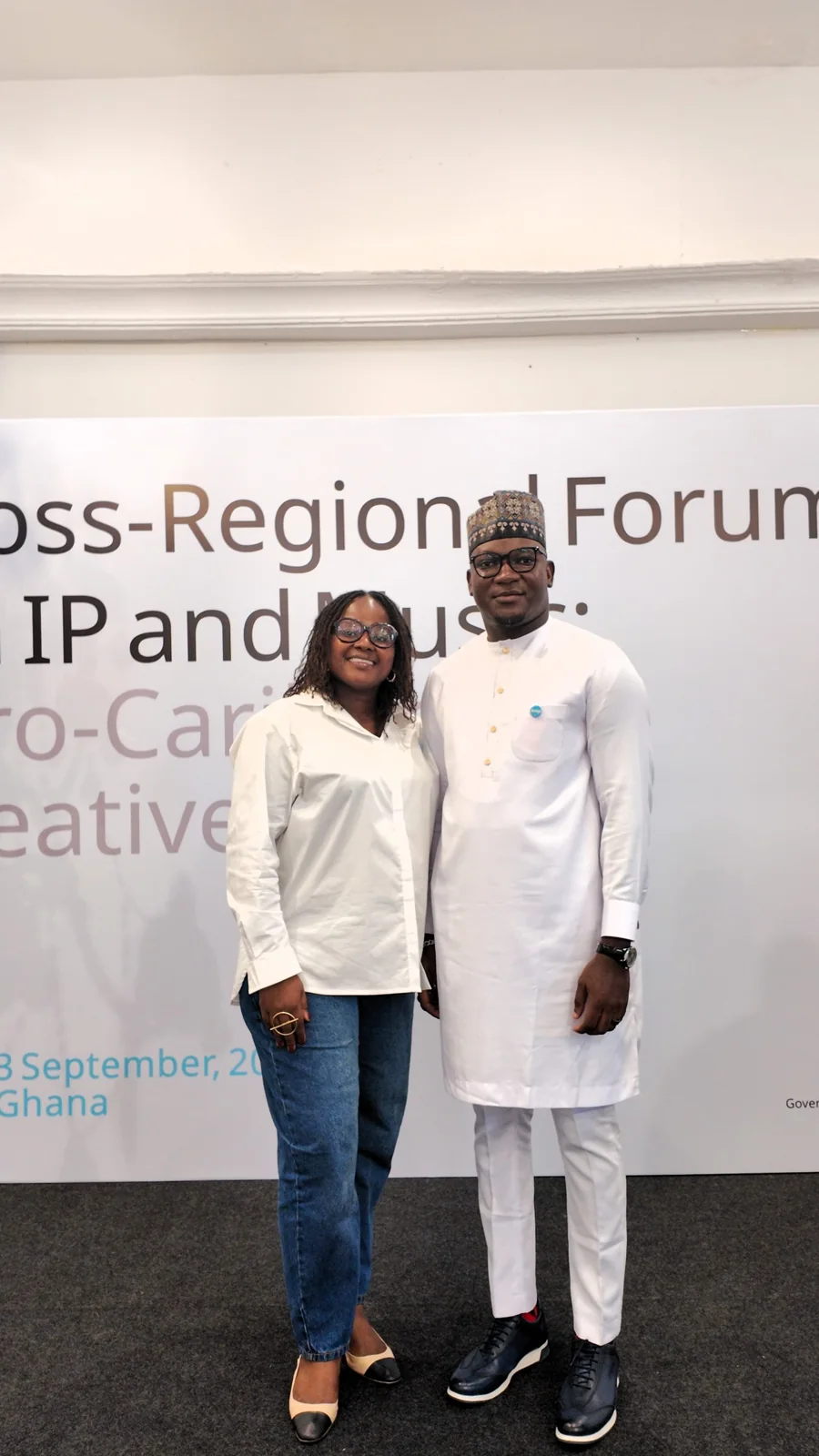 Two participants posing at the creative bridge backdrop