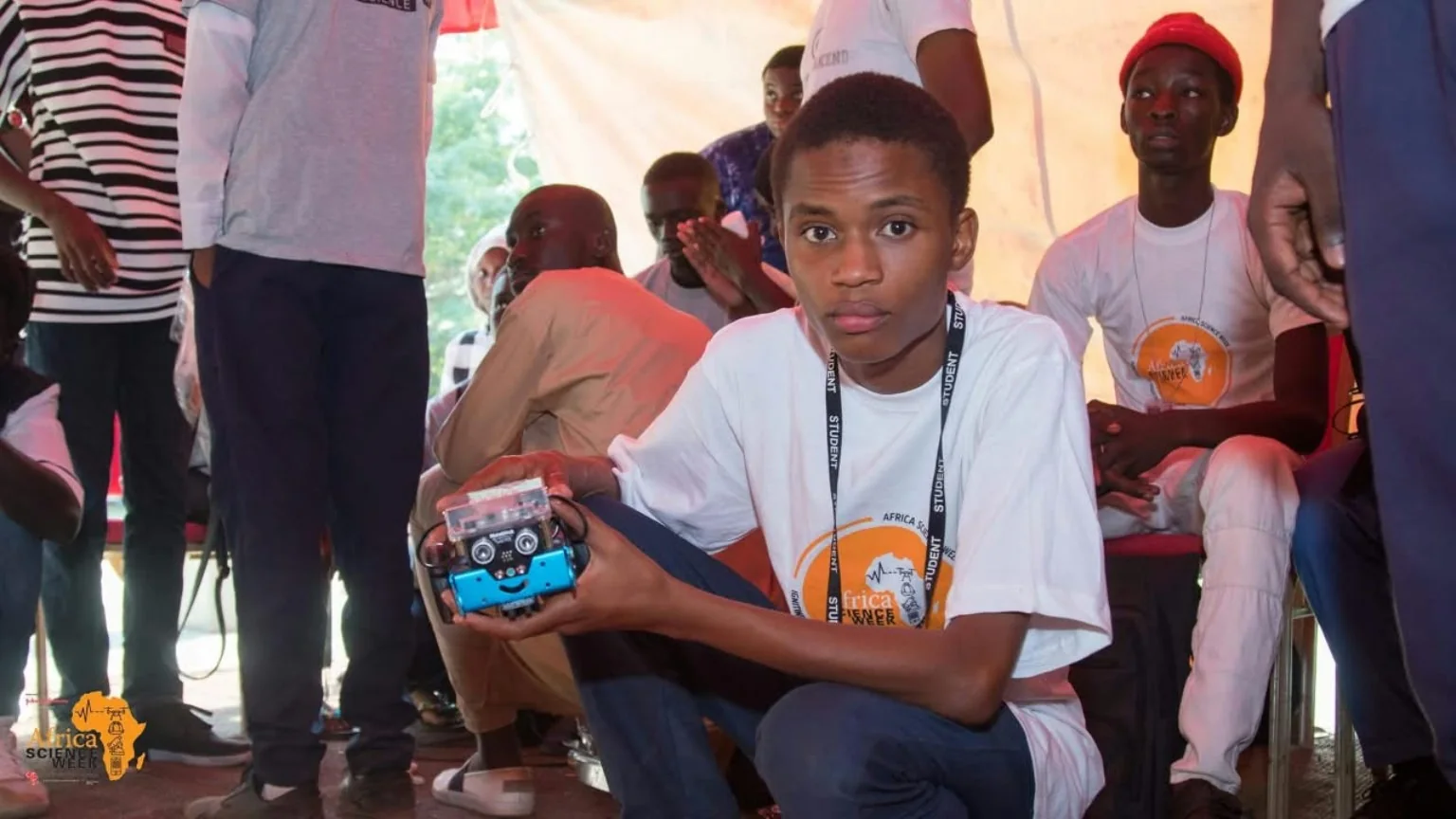 A participant holding a small technology prototype