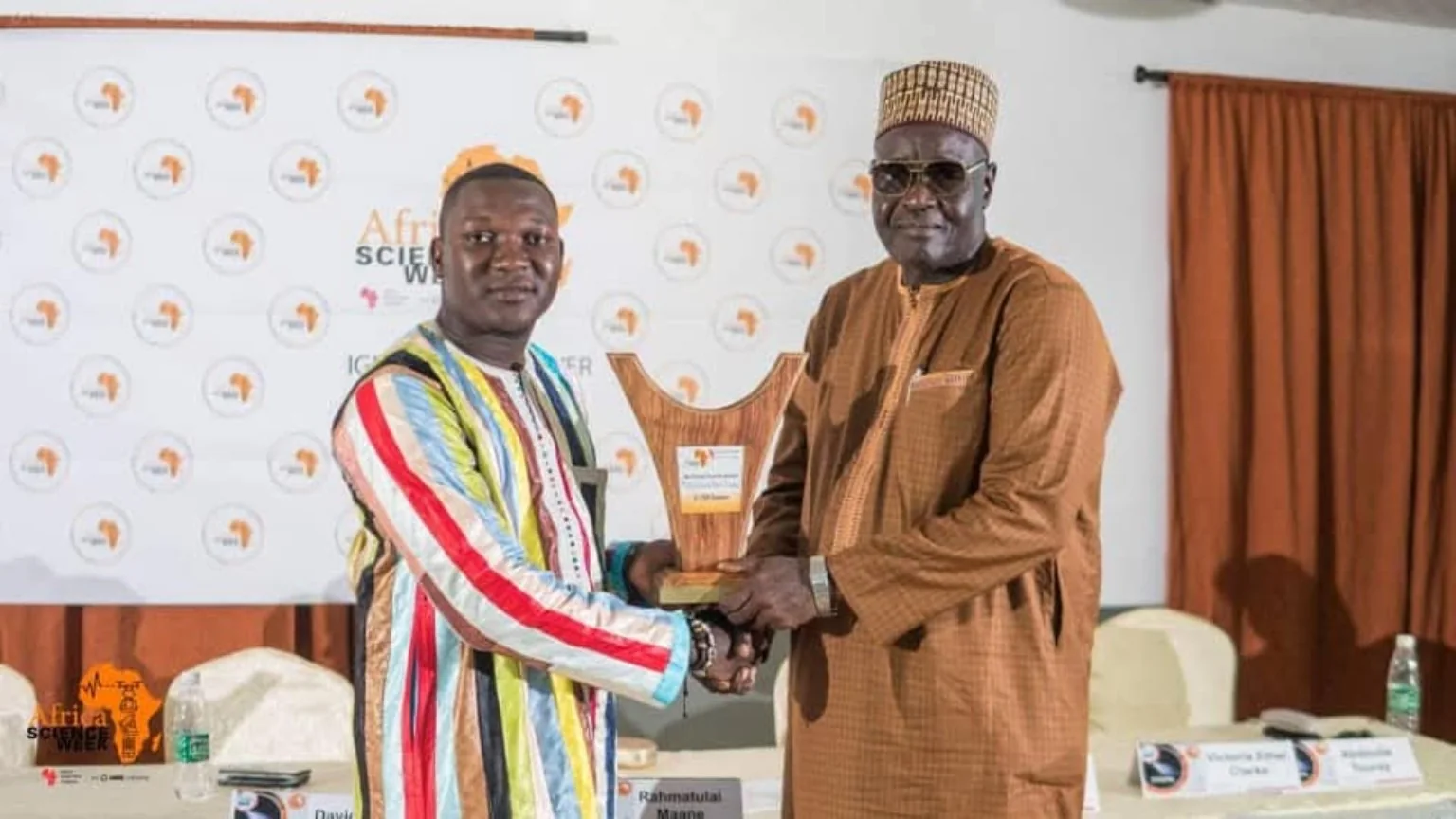 Two participants holding an award at the event