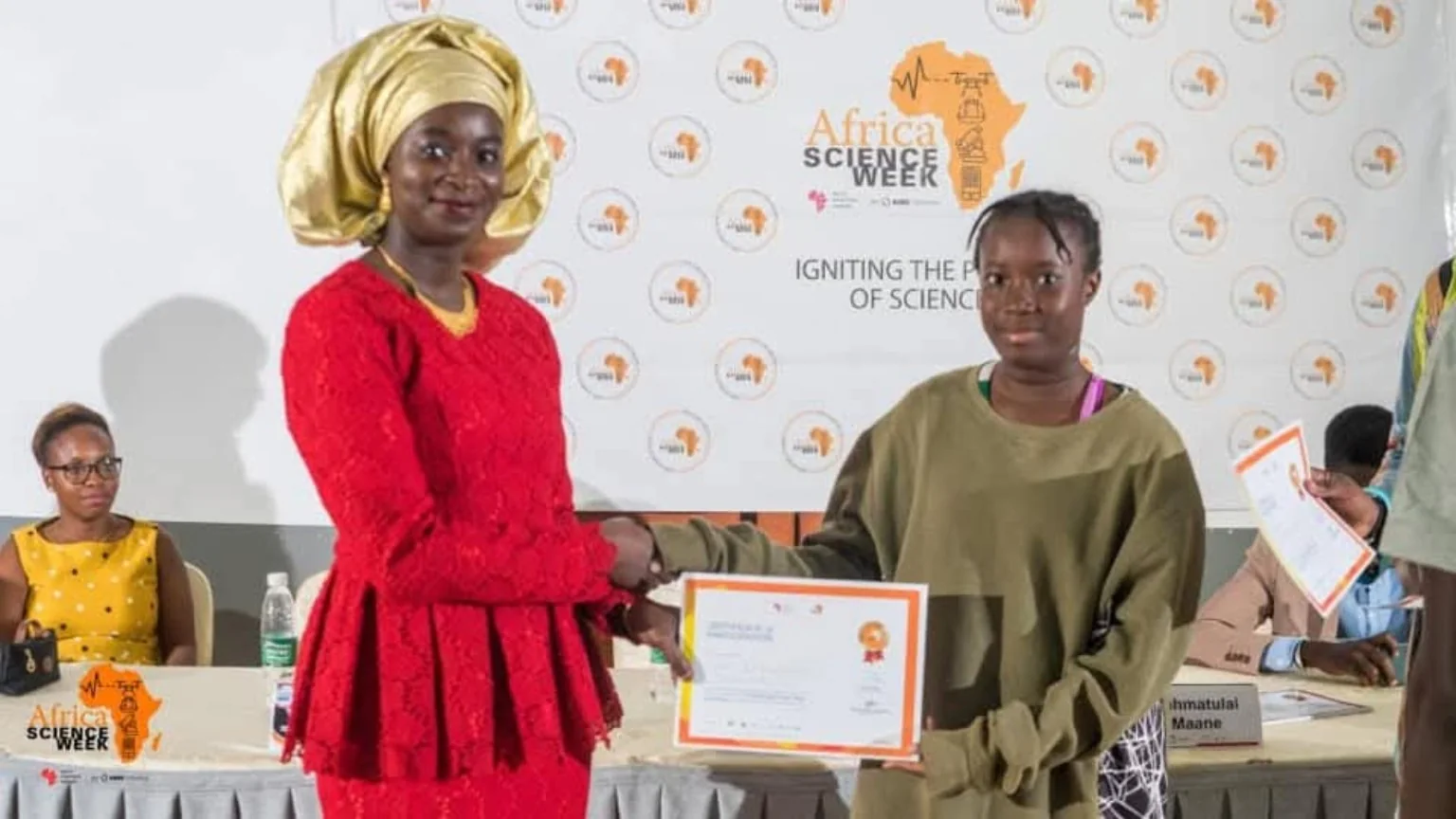 A participant receiving a certificate from a presenter