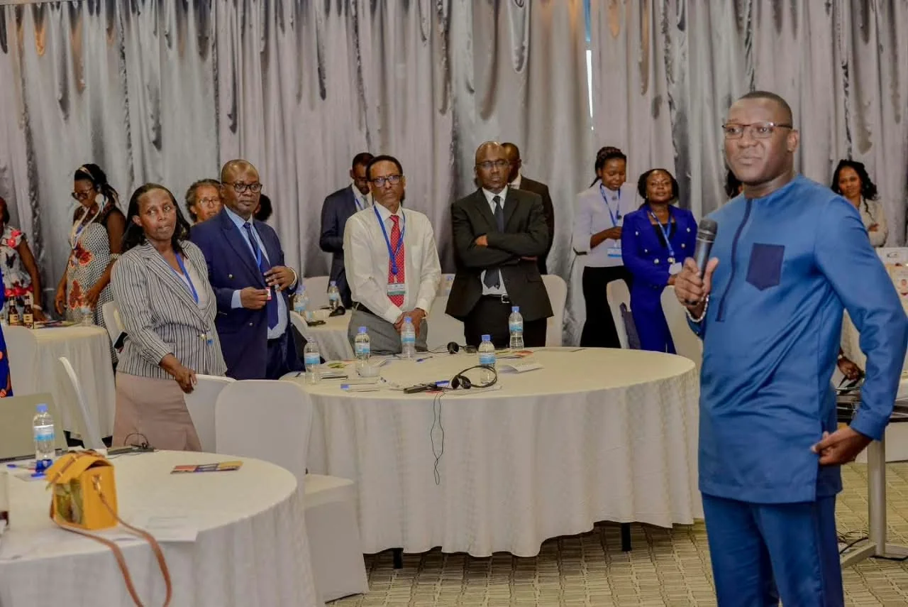 David Jeng holding a microphone beside conference participants